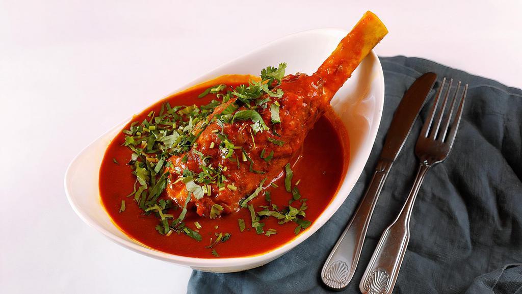 Lamb Shank · Lamb shank marinated overnight with ground spices and carefully braised in onion and tomato sauce.