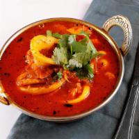 Mixed Seafood Curry · Mixture of grilled salmon, shrimp, and calamari cooked in onion and tomato gravy with aromat...