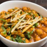 Chana Masala · Vegan. Spicy chickpeas cooked in tomato and onion gravy with Indian spices.