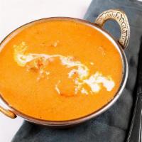 Butter Chicken Masala · Strips of dark chicken meat cooked in tandoor and simmered in creamy tomato and onion sauce.