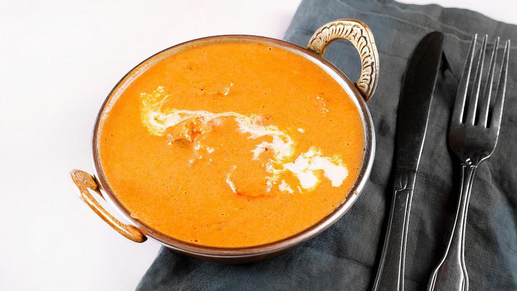Butter Chicken Masala · Strips of dark chicken meat cooked in tandoor and simmered in creamy tomato and onion sauce.