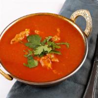 Chicken Curry · North Indian style chicken curry cooked in onion and tomato base sauce with fresh ground and...