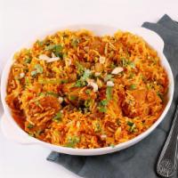 Chicken Biryani · Boneless spiced chicken cooked with basmati rice, onions, bell pepper, and nuts.