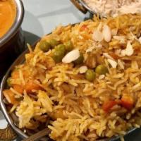 Vegetable Biryani · Garden fresh vegetables cooked with basmati rice in a blend of mild spices, nuts and raisins.