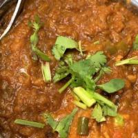 Baingan Bharta · Mashed roasted eggplant sautéed 
 with fresh tomatoes, onions, ginger, green peas, light cre...