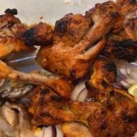 Tandoori Chicken · Bone-in skinless chicken breast and leg marinated overnight in yogurt and freshly grounded s...