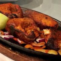 Tandoori Fish · Flaky catfish marinated in our house blend and baked in the tandoor.