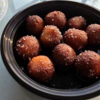 Gulab Jamun · Served warm. Dumpling made with dry milk in sweet syrup flavored with cardamom.