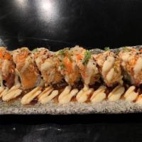 Titanic Roll · Shrimp tempura, cucumber, topped with salmon, tuna, spicy crab, and house unagi sauce.