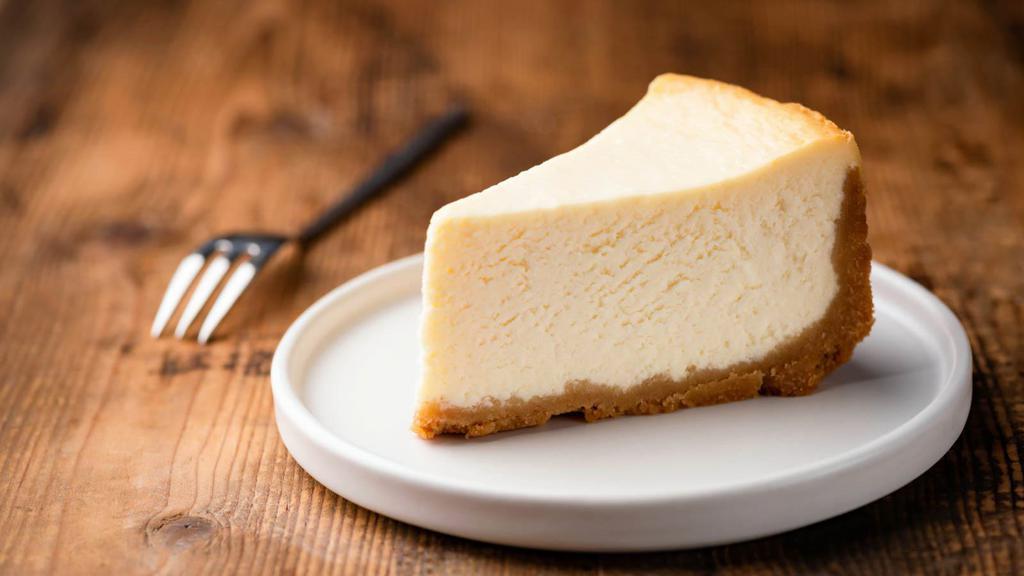 New York Cheesecake · A creamy and rich New York cheesecake sitting on a graham cracker base.