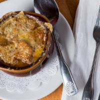 Soupe a L’Oignon · Most popular. French onion soup served with crouton smothered with gruyere cheese.
