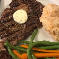 Ribe Eye Steak 10oz · Served with sauteed green beans and baby carrots. Your 
choice of herbed French fries or hom...