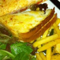 Croque-Monsieur · Croque-monsieur on a pain de mie bread with bechamel sauce, gruyere cheese and ham. Served w...