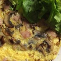 Omelette Parisienne · Mushrooms, swiss cheese, ham. Served with a side salad.