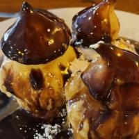 Vanilla Butterscotch Profiteroles · Pate a choux puffs filled with vanilla ice, drizzled with butterscotch sauce.