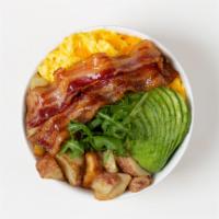 Bacon Breakfast Bowl · 2 Fried Eggs, Bacon, Crispy Potatoes, Shredded Cheese, and Sliced Avocado over Arugula