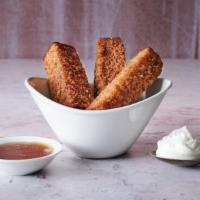 French Toast Sticks · Baked French toast sticks with whipped cream and warm maple syrup for dipping