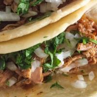Pollo Taco · two tacos filled with grilled marinated chicken served with cilantro, onion, and lime, with ...