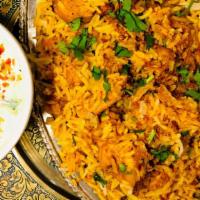Chicken Biryani · Basmati rice from India cooked with saffron, herbs and served with raitha.