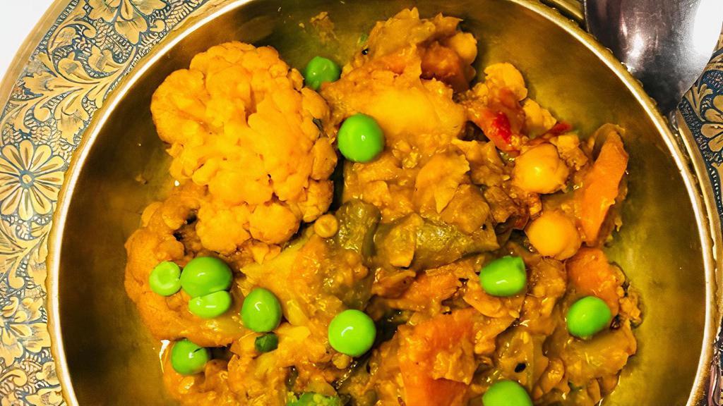 Spiced Vegetables Curry · Combination of cauliflower, beans, carrots, bell peppers, tomatoes and potatoes in a medium sauce.