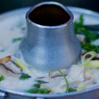 Tom Ka Gai · Chunks of chicken breast set in a silky, rich coconut broth flavored with mushrooms, lemongr...