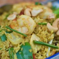 Pineapple Fried Rice · Fried rice with sliced chicken, prawns, garlic, onions, pineapple, cashew nuts, bell pepper,...