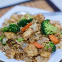 Pad See Ewe · Thick, pan-fried noodles turned with egg, garlic, pepper, bean sauce, cabbage and broccoli w...