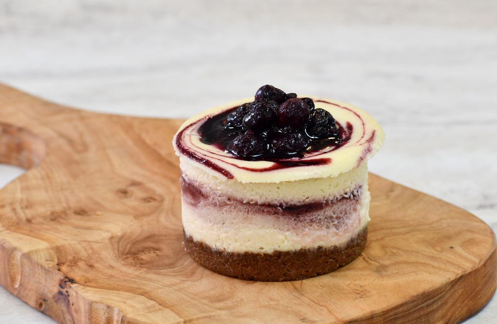 Beet & Berry Cheesecake · Our signature cheesecake — a creamy filling with delicious swirls of a fruit purée reduction made with roasted sweet beets, blueberries and red wine and topped with  berry compote.