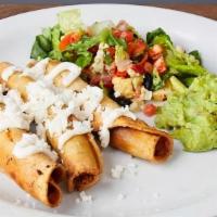 FLAUTAS :: · Three crunchy rolled tacos topped with Mexican crema and queso fresco. Served with a side sa...
