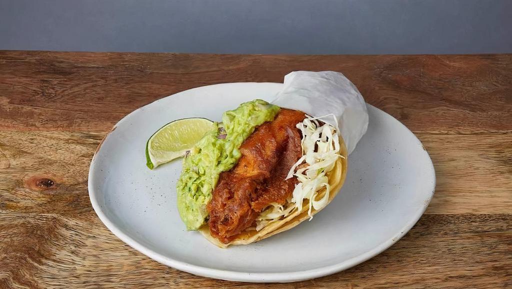 NICK'S WAY BAJA TACO :: · Beer-battered fish in a crispy tortilla wrapped in a soft tortilla. With Jack cheese, guacamole, cilantro, cabbage, red onions, salsa roja, & baja sauce (tangy aioli)