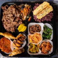 Bulgogi Doshirak - BBQ Rib Eye Beef · Includes 
Choice of Rice, Meat, Japchae, Egg, Seasonal side dishes, Kimchi, Mandu, Korean Pa...