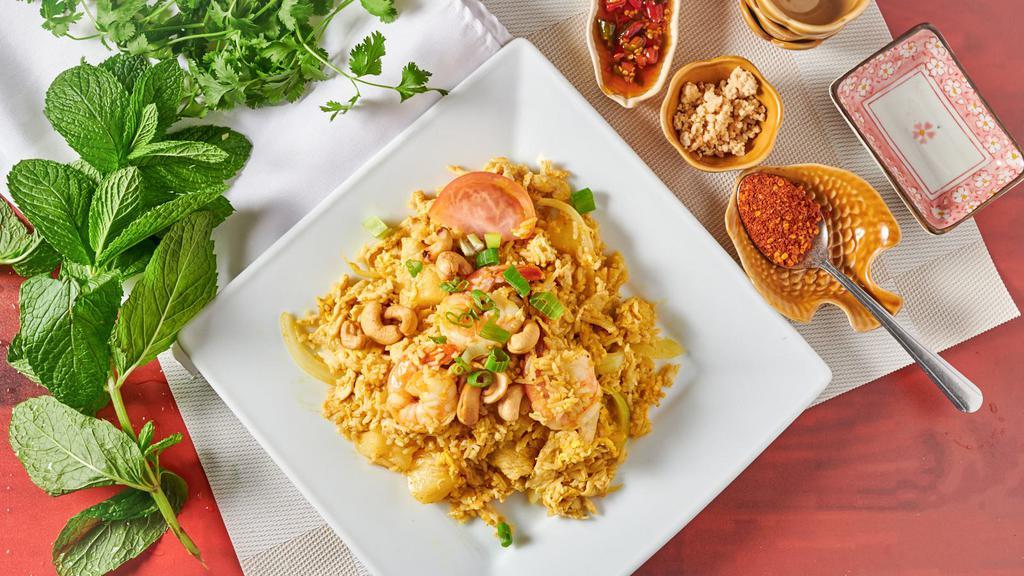 68. Pineapple Fried Rice · Exotic fried rice with chicken, prawns, pineapple, cashew nuts, green onions, tomatoes, and curry powder.