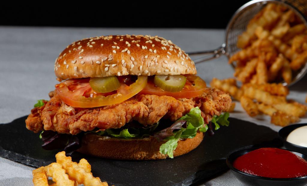 Ultimate Spicy Crispy Chicken Sandwich · Breaded crispy chicken patty, 2 chicken tenders, hot sauce, tomatoes, onions, lettuce, del pickles, cheese and garlic mayonnaise.