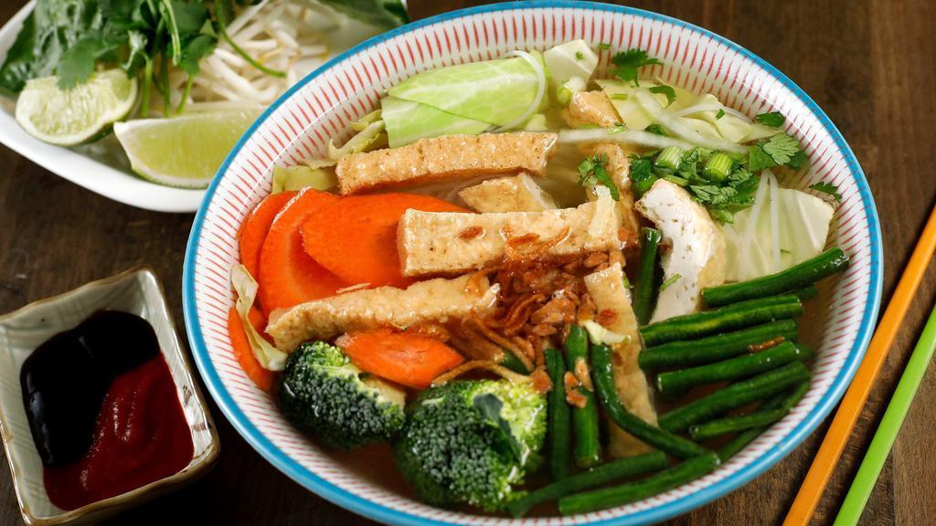 Pho Buddha · Gluten-free. Vegan broth from apples, carrots, kohlrabi, and cabbage. Topped with tofu and vegetables. Home-made, vegan broth served steamy hot in a big bowl with rice noodle, cilantro, basil, onions, lemon wedges, and bean sprout.