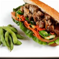 Pork Belly Sandwich · Braised pork belly in coconut juice. Served on an airy French baguette stuffed with home-mad...