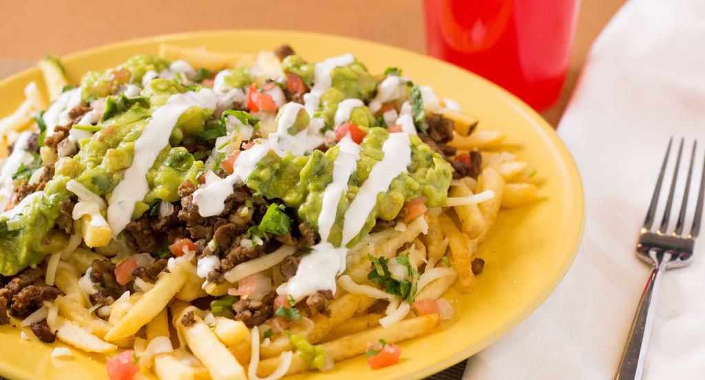 Asada Fries · Served with french fries, cheese, steak, guacamole and salsa ranchera.
