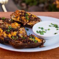 Fully Loaded Pulled Pork Skins · Pulled-pork-stuffed potato skins, sour cream, onions, cheddar cheese, smoked bacon and scall...