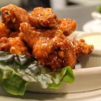 Wings Over Texas · Large & meaty slow smoked, fried crispy bone-in wings tossed in your choice of hot & spicy b...
