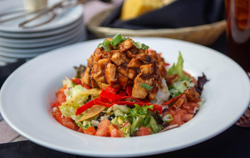 Bbq Chicken Salad · Black beans, sweet corn, jack cheese tossed in ranch dressing. Topped with sliced smoked chicken, BBQ sauce, crispy tortilla chips, tomatoes and green onions.