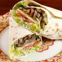 Lamb & Beef · Thin slices of marinated lamb & beef with hummus, tahini sauce, lettuce, tomato and cucumbers.