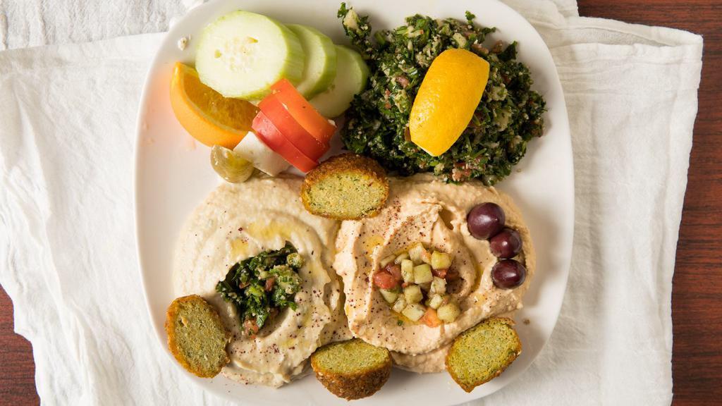 2. Dip Platter · Hummus, babaghanoush, olives, feta, 2 falafel, tomato, cucumbers, pickle slice orange tabouli & 2 pita.