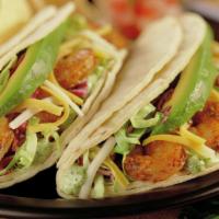 Baja-Style Shrimp Tacos · Two soft corn tortilla tacos filled with grilled shrimp and crisp cabbage topped with baja s...