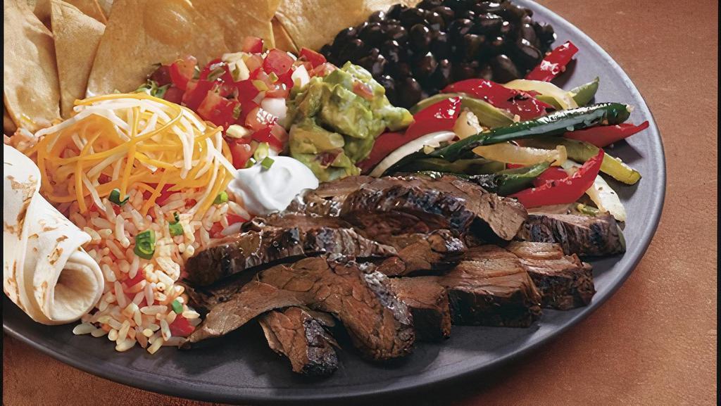 3 Pepper Fajita · Grilled chicken or sirloin steak, fire-roasted fajita veggies, guacamole, cheese and sour cream. Served with corn or flour tortillas, choice of beans and rice.