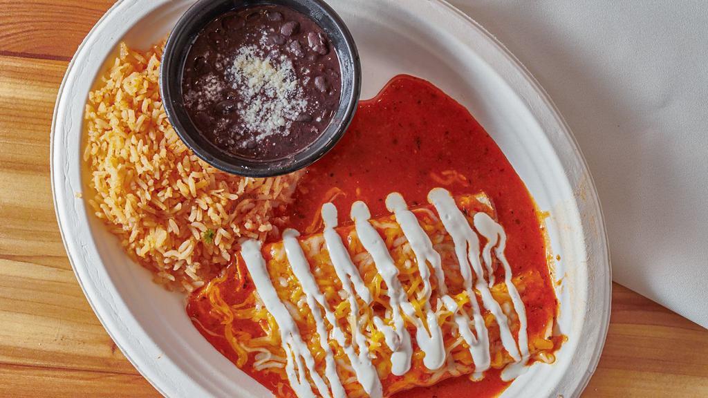 Cheese Enchilada · Vegetarian. Blend of jack and cheddar cheeses rolled in a pair of corn tortillas covered with melted cheese, roja sauce and crema mexicana. Served with choice of beans and rice.
