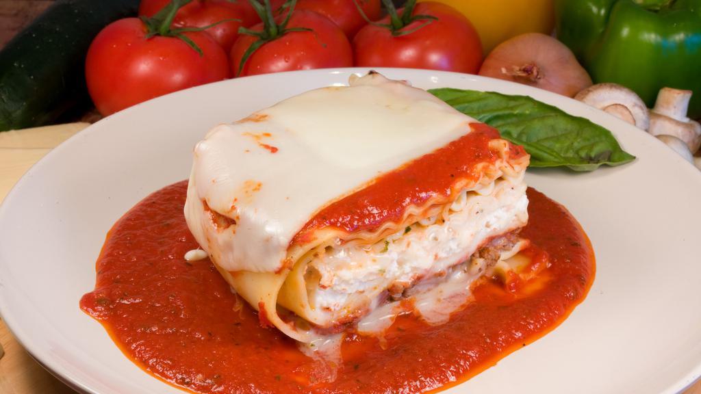 Lasagna · Lasagna noodles with seasoned ground beef, ricotta, mozzarella cheese with marinara sauce.