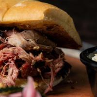 Regular Pulled Pork · Slow cooked for several hours and served with our vinegar molasses hog wash. Served with you...