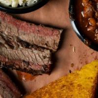 Regular Brisket Meal · Our hand cut smoked beef brisket.  Served with your choice of two sides and bread.