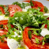 Caprese · Fresh mozzarella, tomato, basil, and extra virgin olive oil.