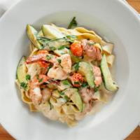 Pappardelle Al Salmone · Handmade pappardelle with smoked salmon, prawns, and zucchini in a light cream sauce.