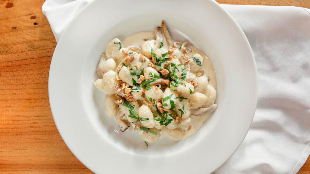 Gnocchi Al Gorgonzola · Mushrooms, gorgonzola, and walnuts in a light cream sauce.